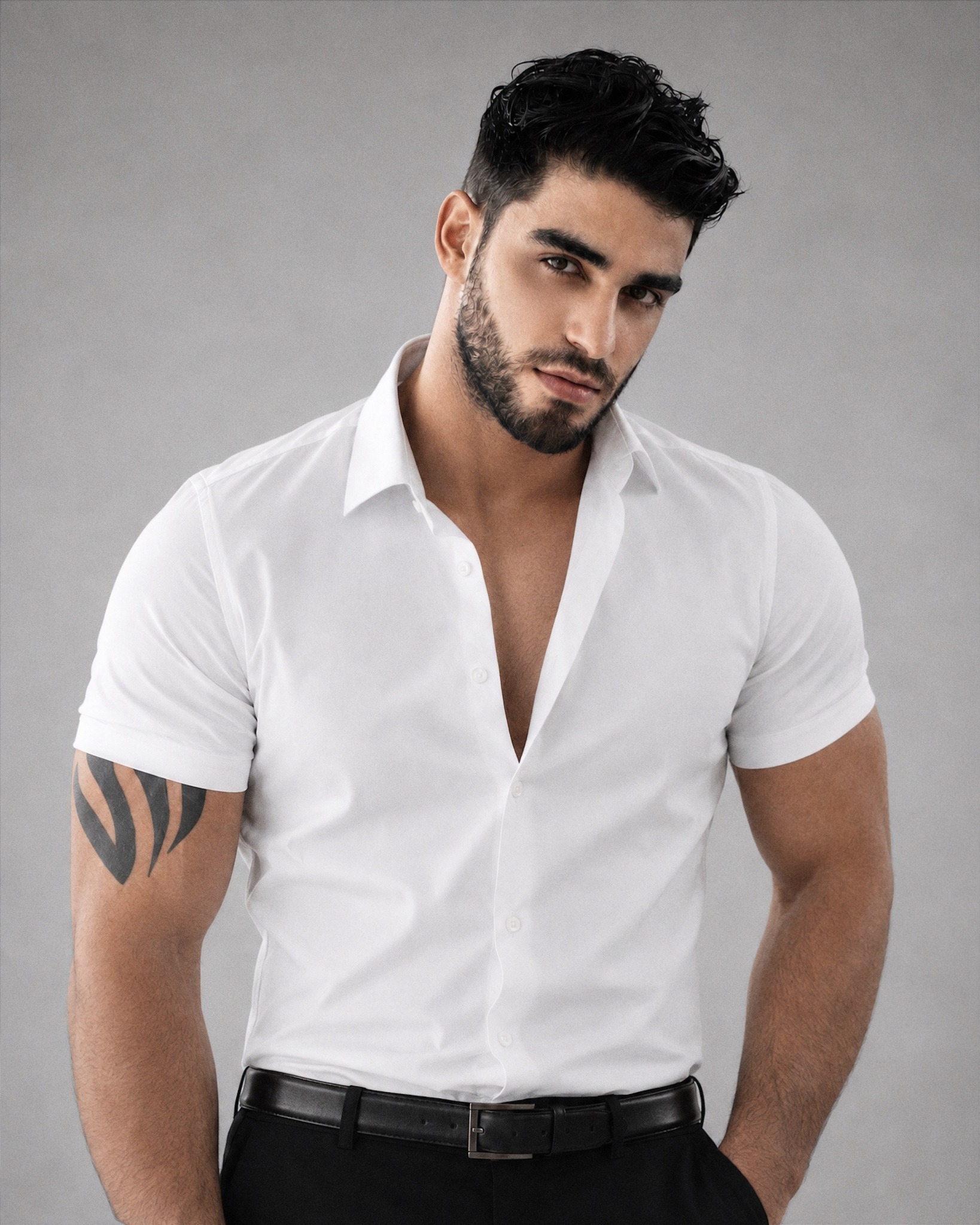Firat Zan in a white shirt against a grey studio background