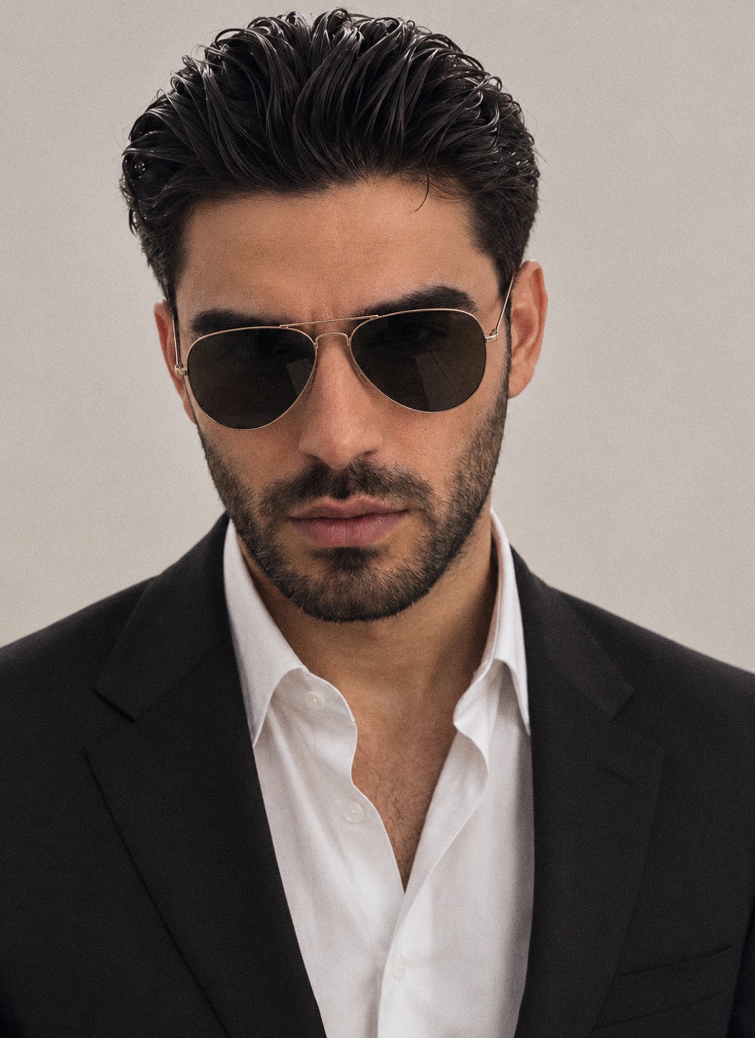 Firat Zan wearing aviator sunglasses and a dark suit for his property investment Journal article